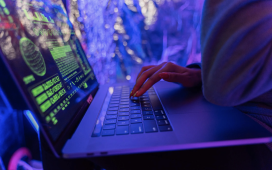 an individual examining code on a laptop