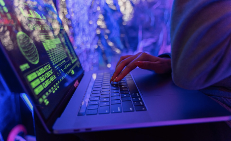 an individual examining code on a laptop